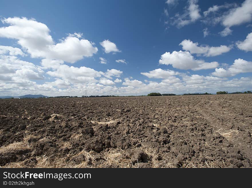 A freshly plowed grass farm in Oregon in early fall. A freshly plowed grass farm in Oregon in early fall