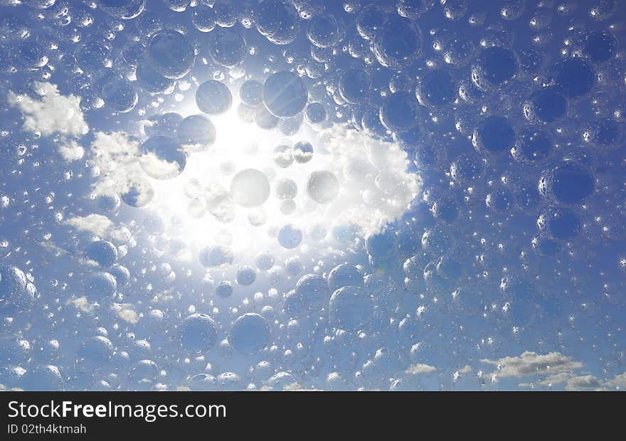 Lots of bubbles against a bright shining sun and blue sky. Lots of bubbles against a bright shining sun and blue sky