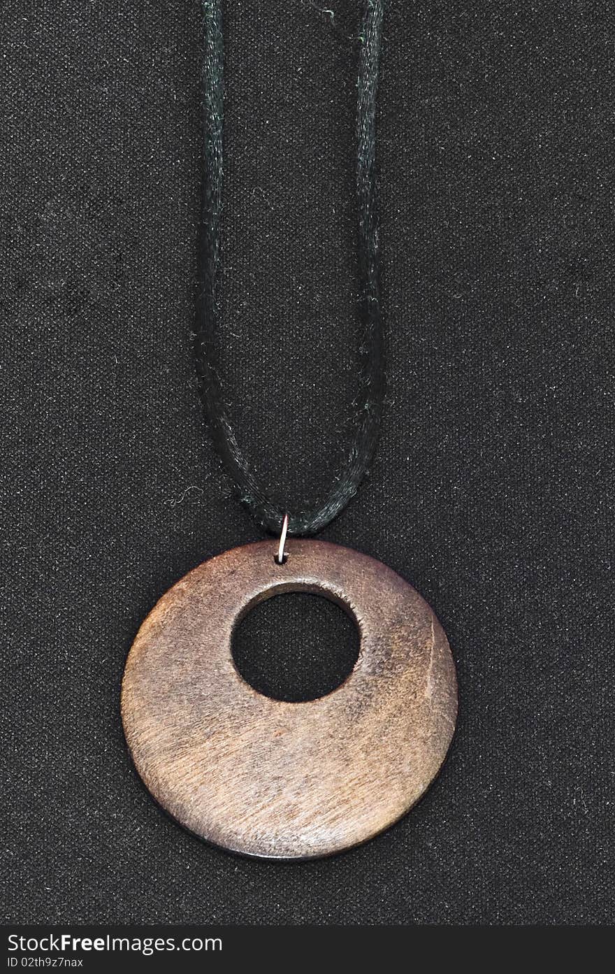 Brown wooden necklace on black background