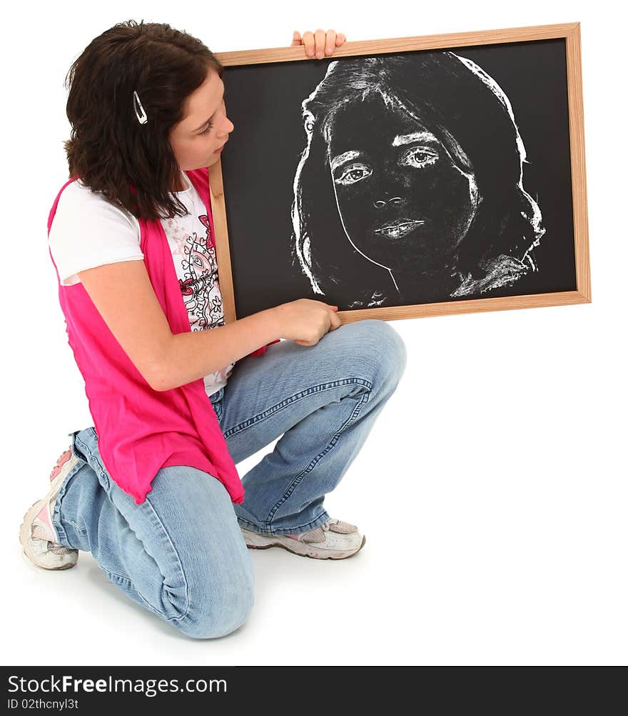 Beautiful american 12 year old girl with chalkboard drawing of herself over white. Beautiful american 12 year old girl with chalkboard drawing of herself over white.