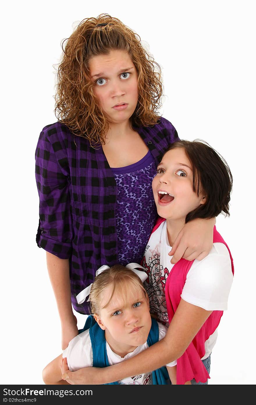 Adorable american sisters making silly faces over white background. Adorable american sisters making silly faces over white background.