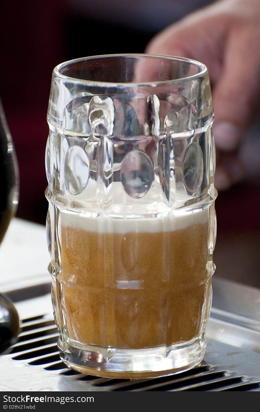 Half glass of beer on the bar counter