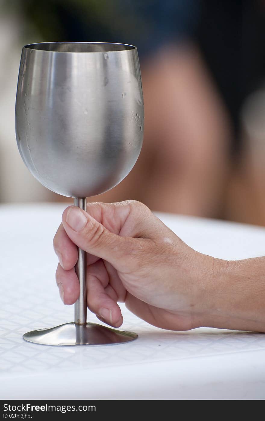 Woman hand holding a stainless steel wine glass. Woman hand holding a stainless steel wine glass