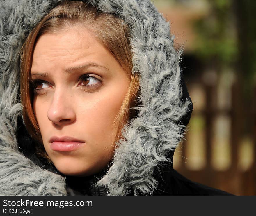 Adult female wearing a winter coat in cool fall weather.