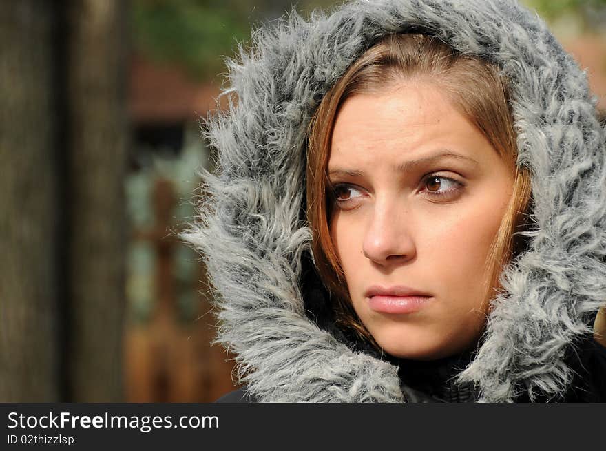 Adult female wearing a winter coat in cool fall weather.