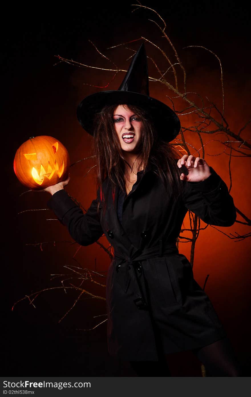 A beautiful woman witha pumpkin in the hand