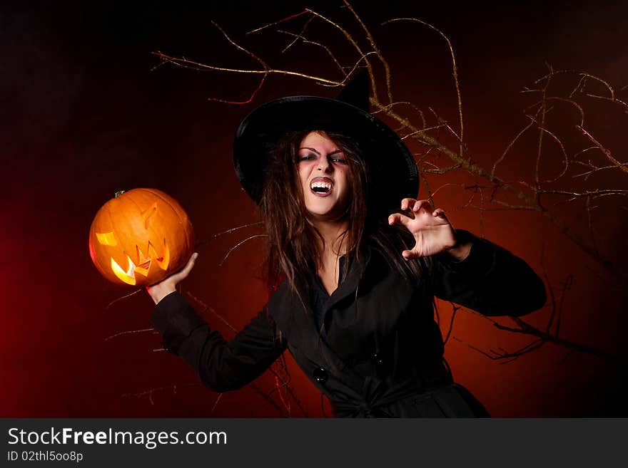 Beautiful woman with a pumpkin in the hands. Beautiful woman with a pumpkin in the hands