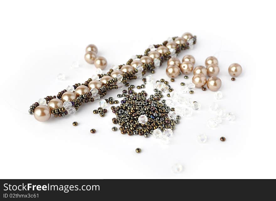 Brown pearl bracelet beading tools isolated on white background