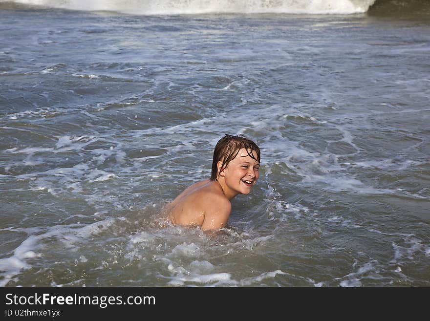 Boy is laughing and has fun in the ocean. Boy is laughing and has fun in the ocean