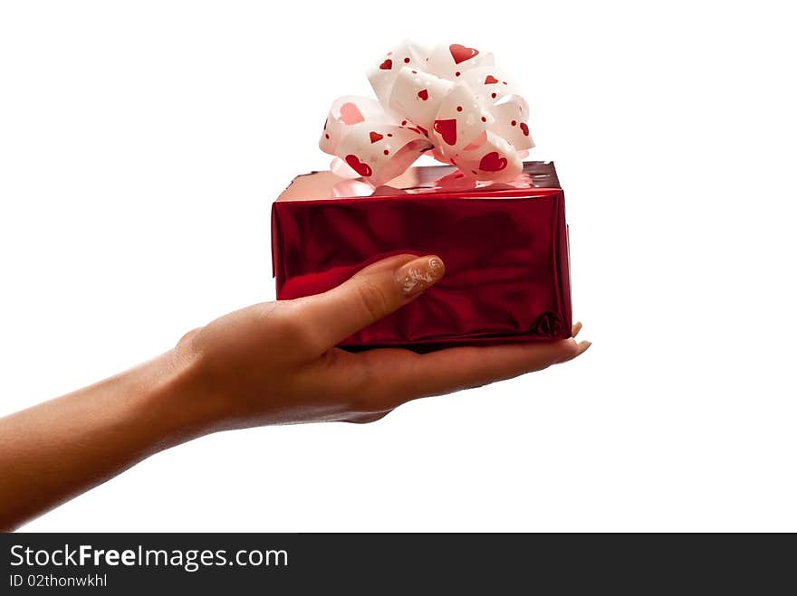 Hand with a red gift box with bow isolated on white background. Hand with a red gift box with bow isolated on white background