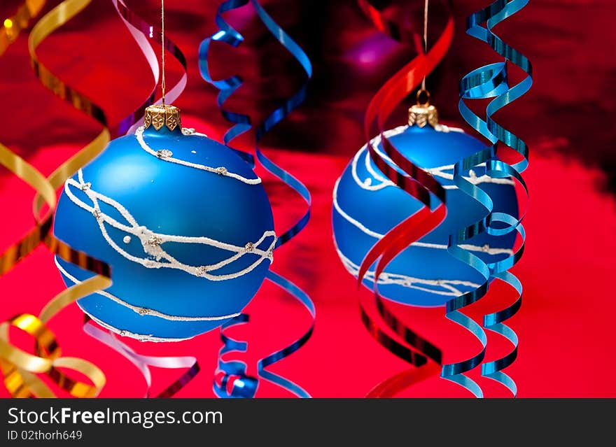 Christmas decoration from two blue balls on red background. Christmas decoration from two blue balls on red background