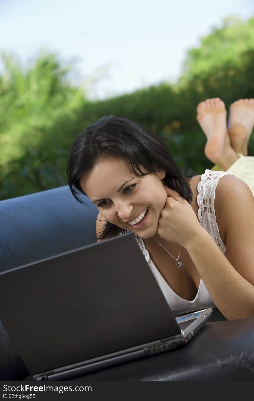 Portrait of woman with laptopm in summer environment. Portrait of woman with laptopm in summer environment