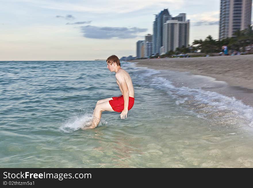 Boy jumps with speed into the ocean