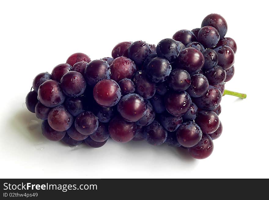 A cluster of fresh grapes isolated on a white background.