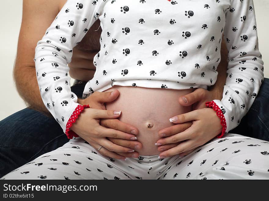 An image of pregnant woman abdomen with hands on it. An image of pregnant woman abdomen with hands on it