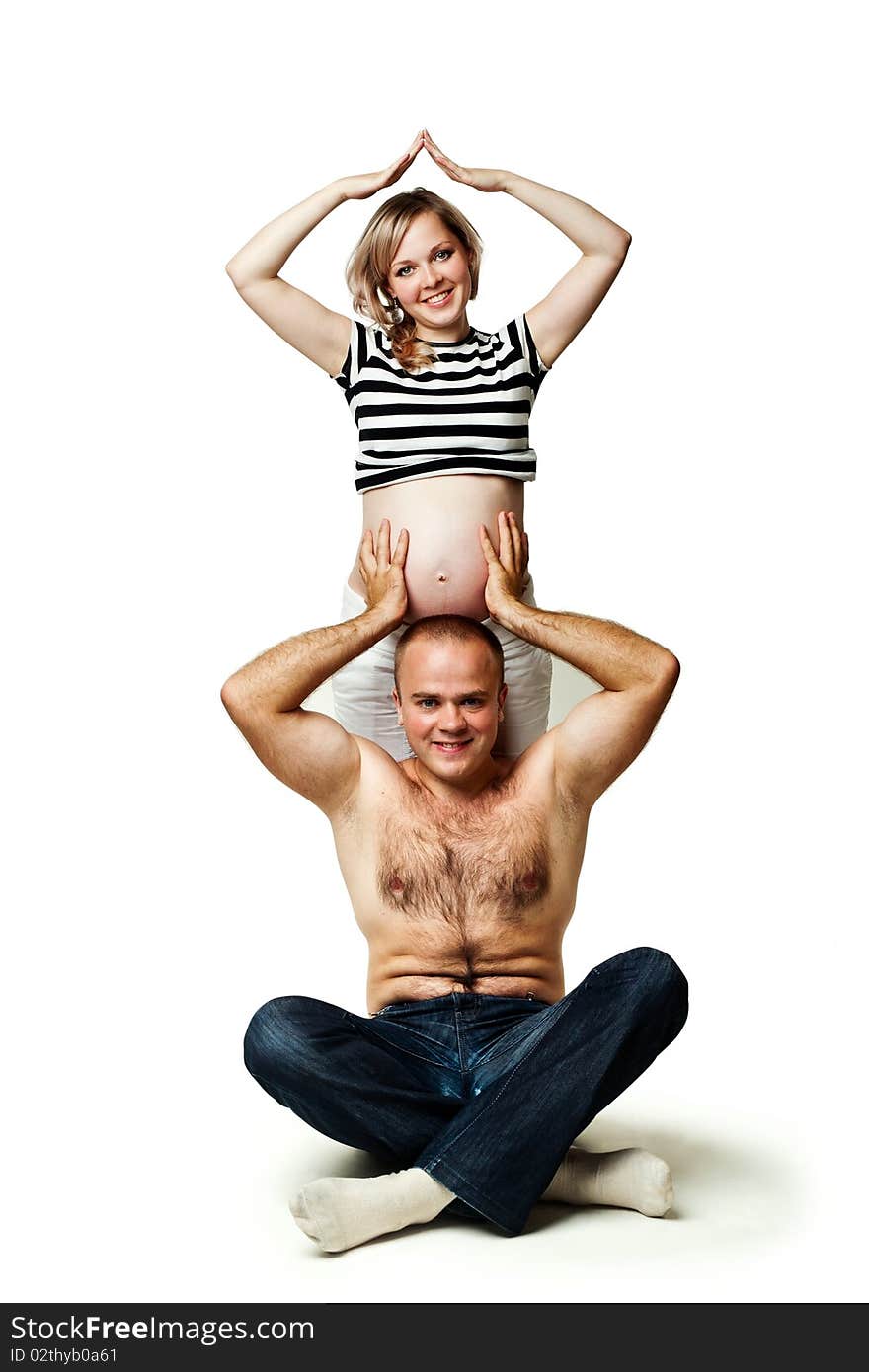 An image of a man supporting his pregnant wife. An image of a man supporting his pregnant wife