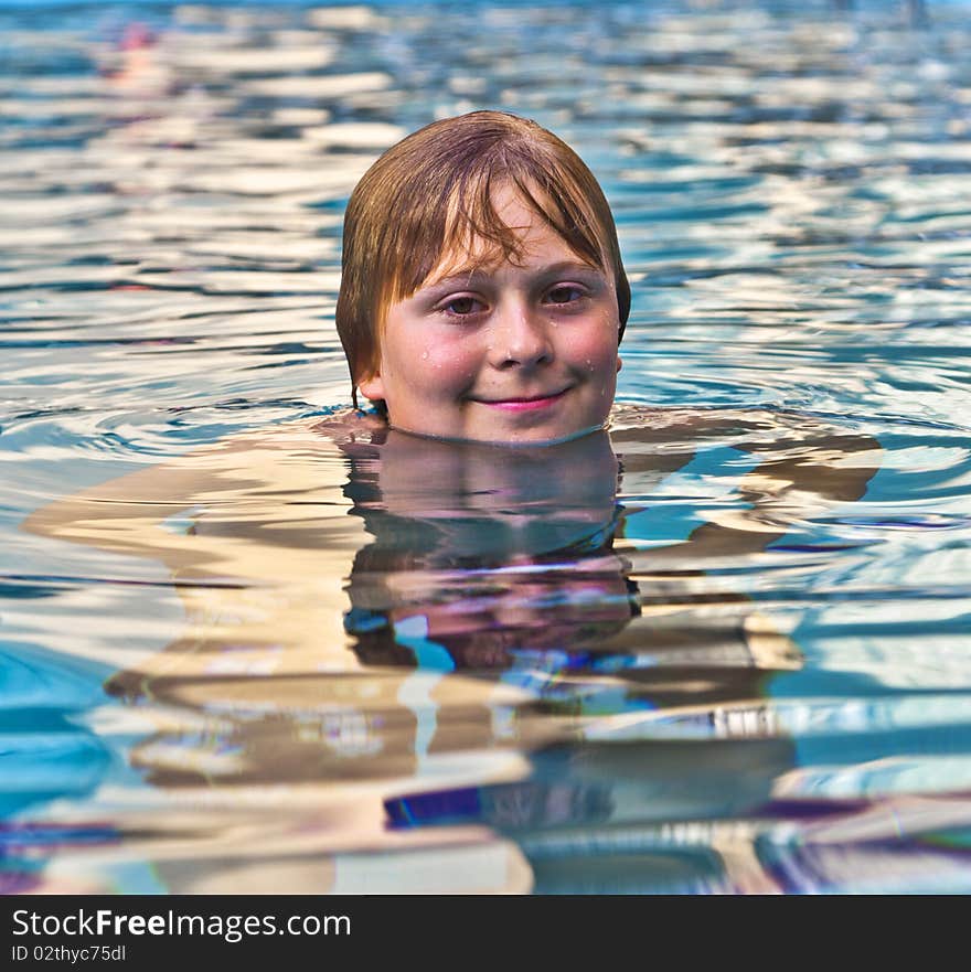 Boy Enjoys Swimming In The Pool