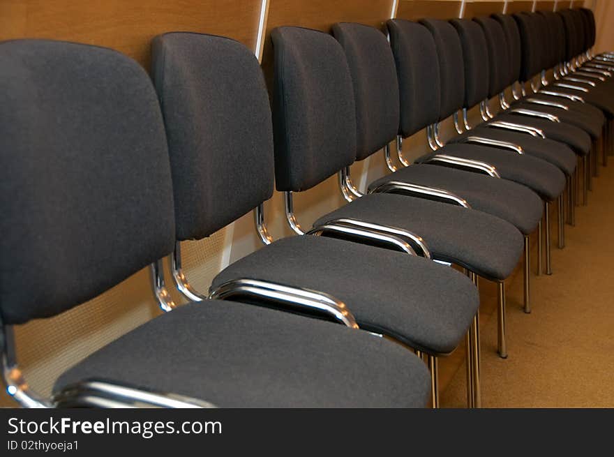 Empty chairs stand in a row. Empty chairs stand in a row