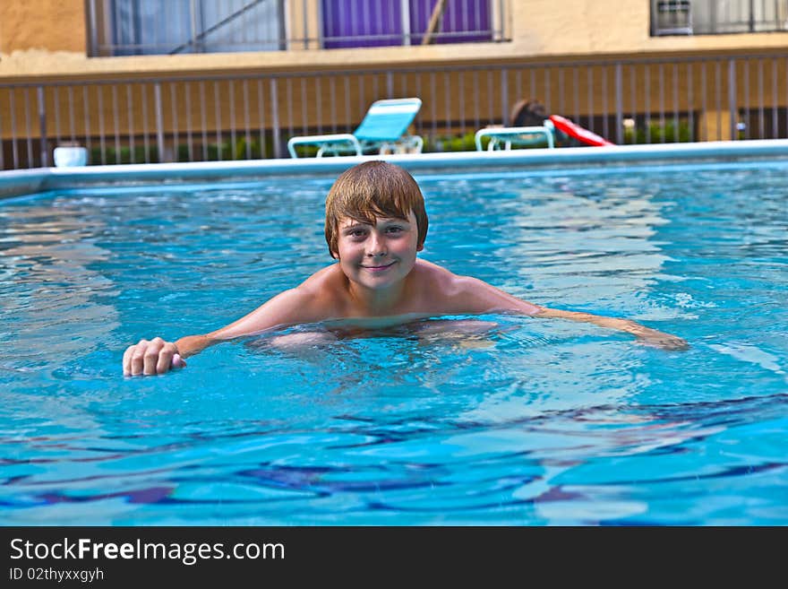 Boy Enjoys Swimming In The Pool