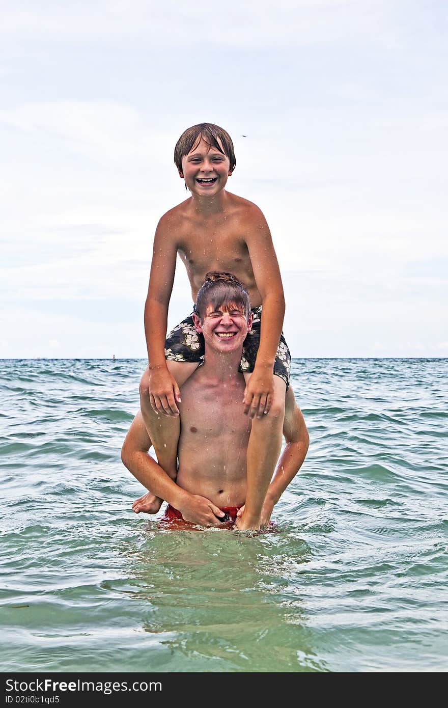 Boys having fun in the beautiful clear sea