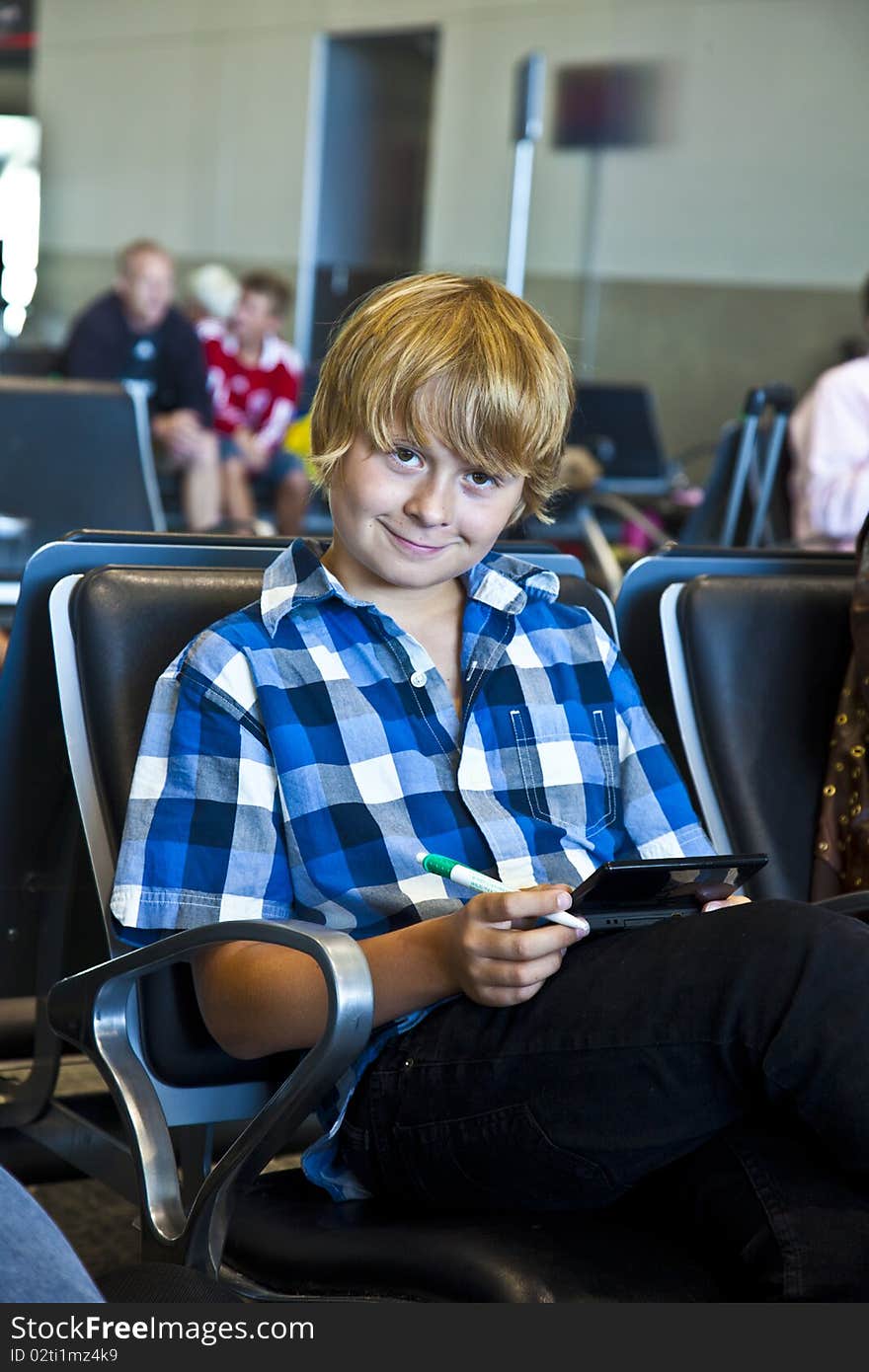 Boy Is Waiting For Departure At The Airport