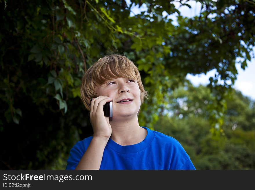 Young boy talking on a cell phone.