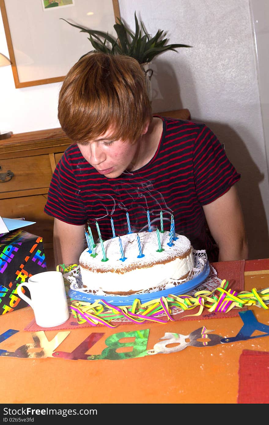 Boy blows out his birthday candles on the cake