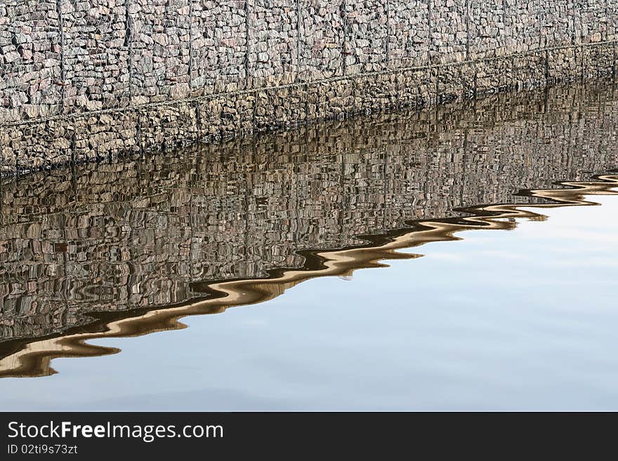 Steep river bank and its reflection in water. Steep river bank and its reflection in water