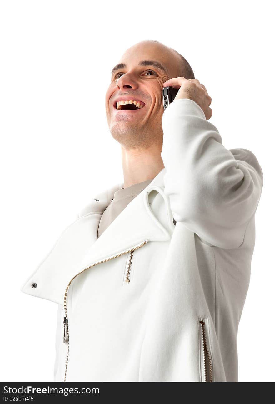 Casual man smiling and talking on a mobile phone isolated over a white background