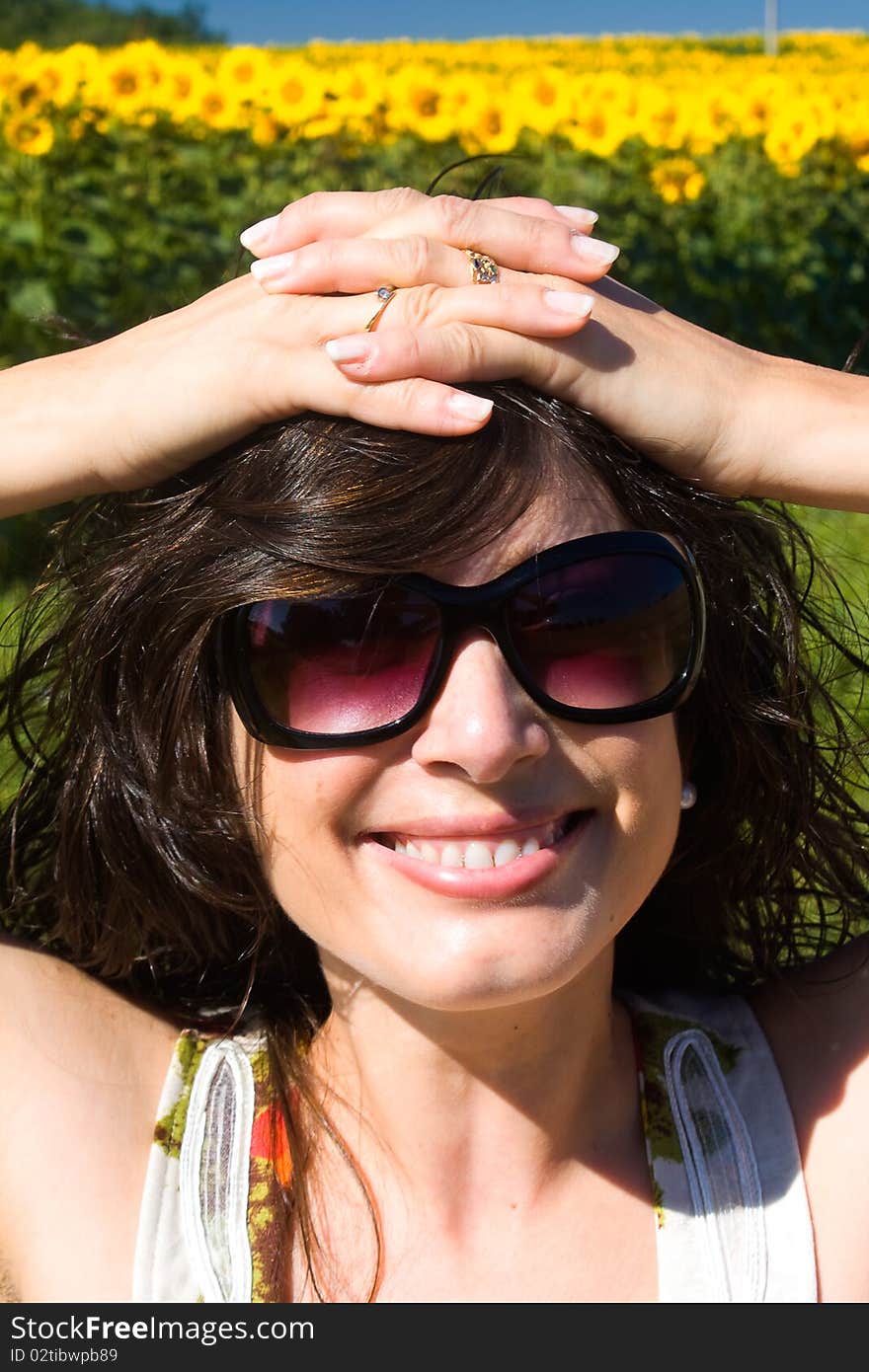 Young beautiful woman on field in summer