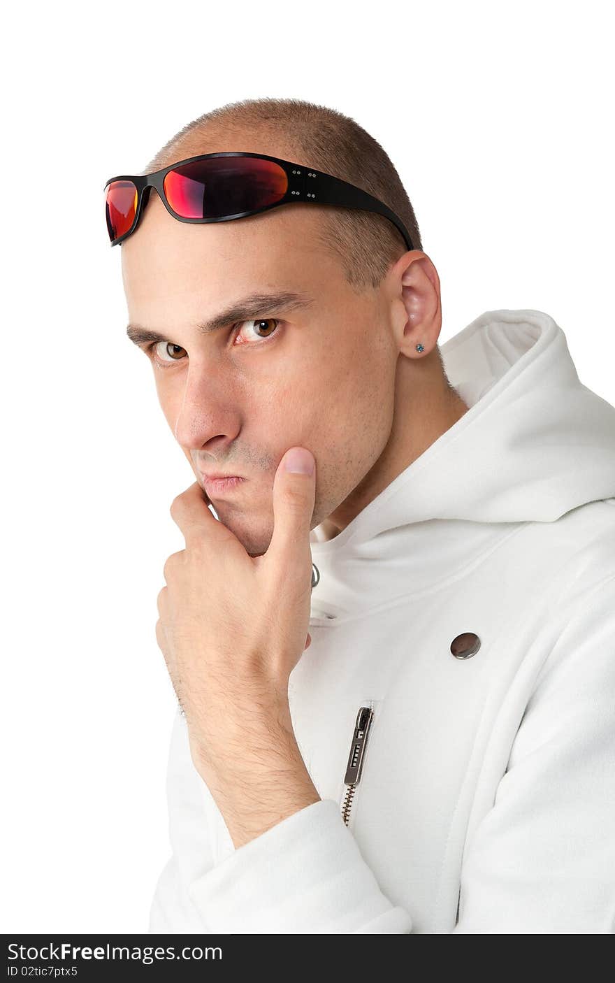 Pensive young man in a white jacket with sunglasses