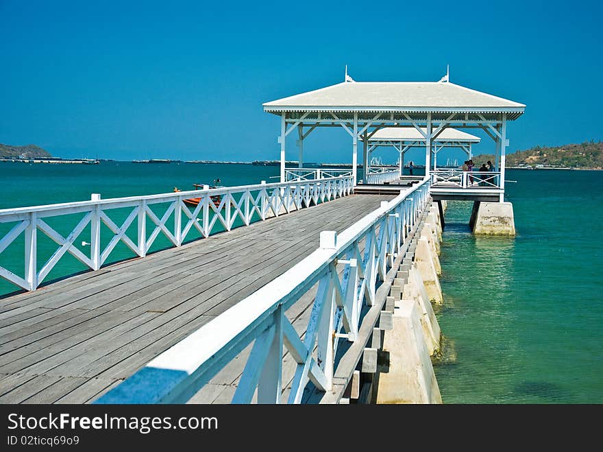 White wood bridge is along in the sea