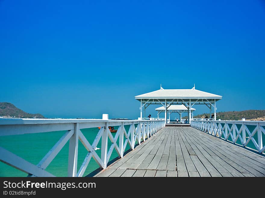 White wood bridge is along in the sea