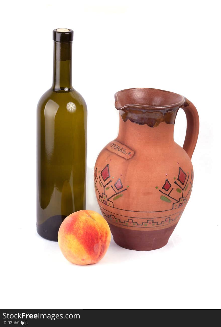 Wine bottle, pot and peach isolated on white background. Wine bottle, pot and peach isolated on white background.