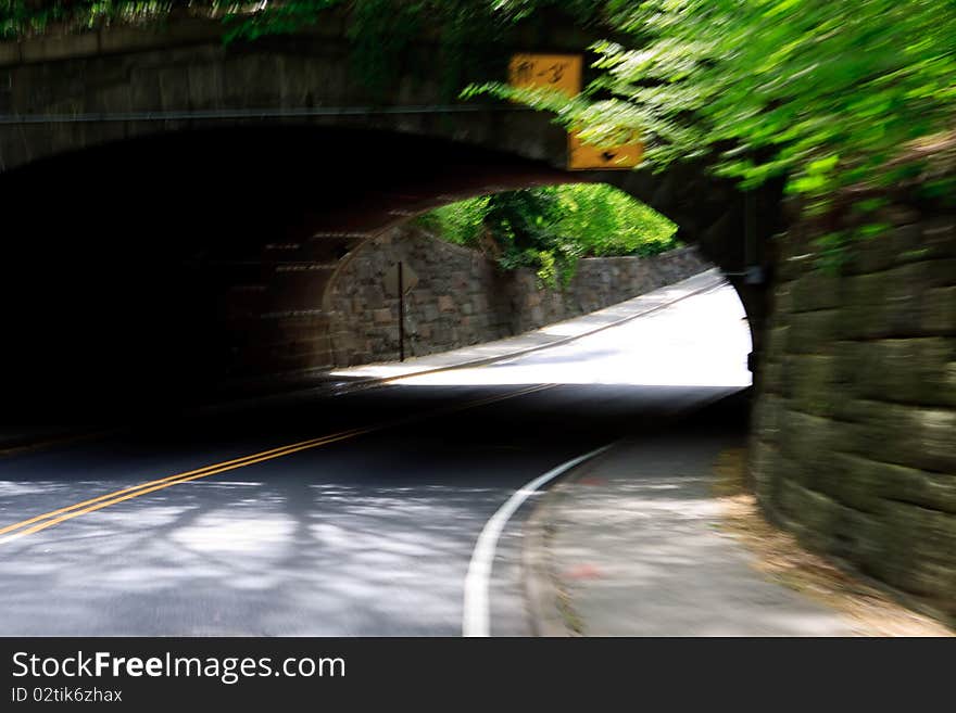 Road in Central Park with tunnel to cross from East Side to West Side of Manhattan in motion