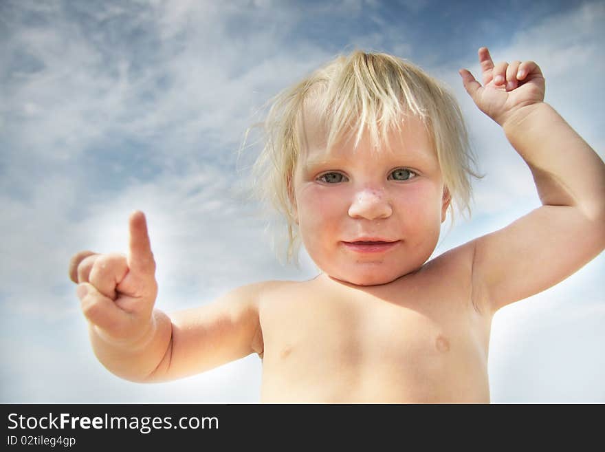 Funny child portrait on sky background