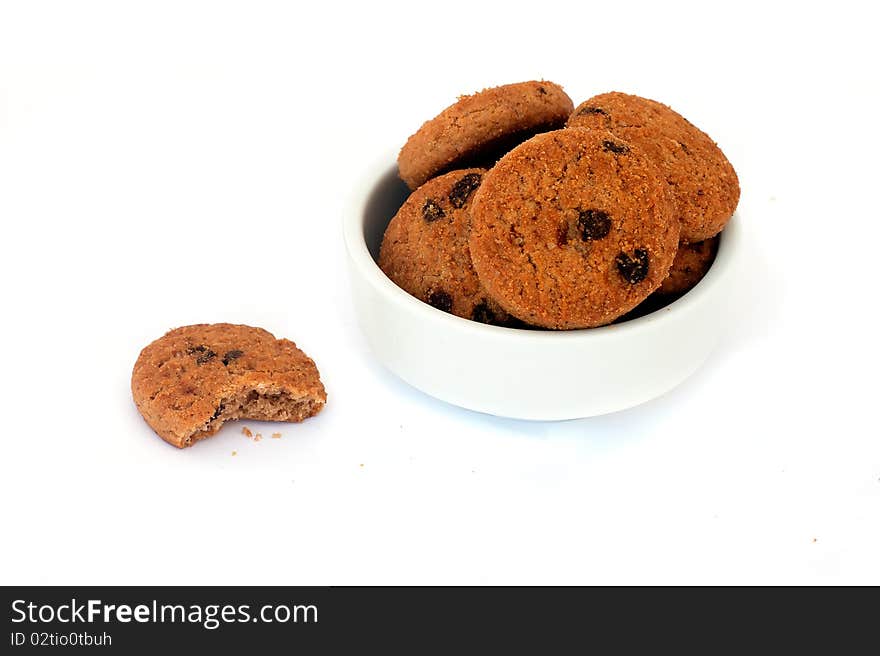 Chocolate cookies in a bowl, isolated on white background