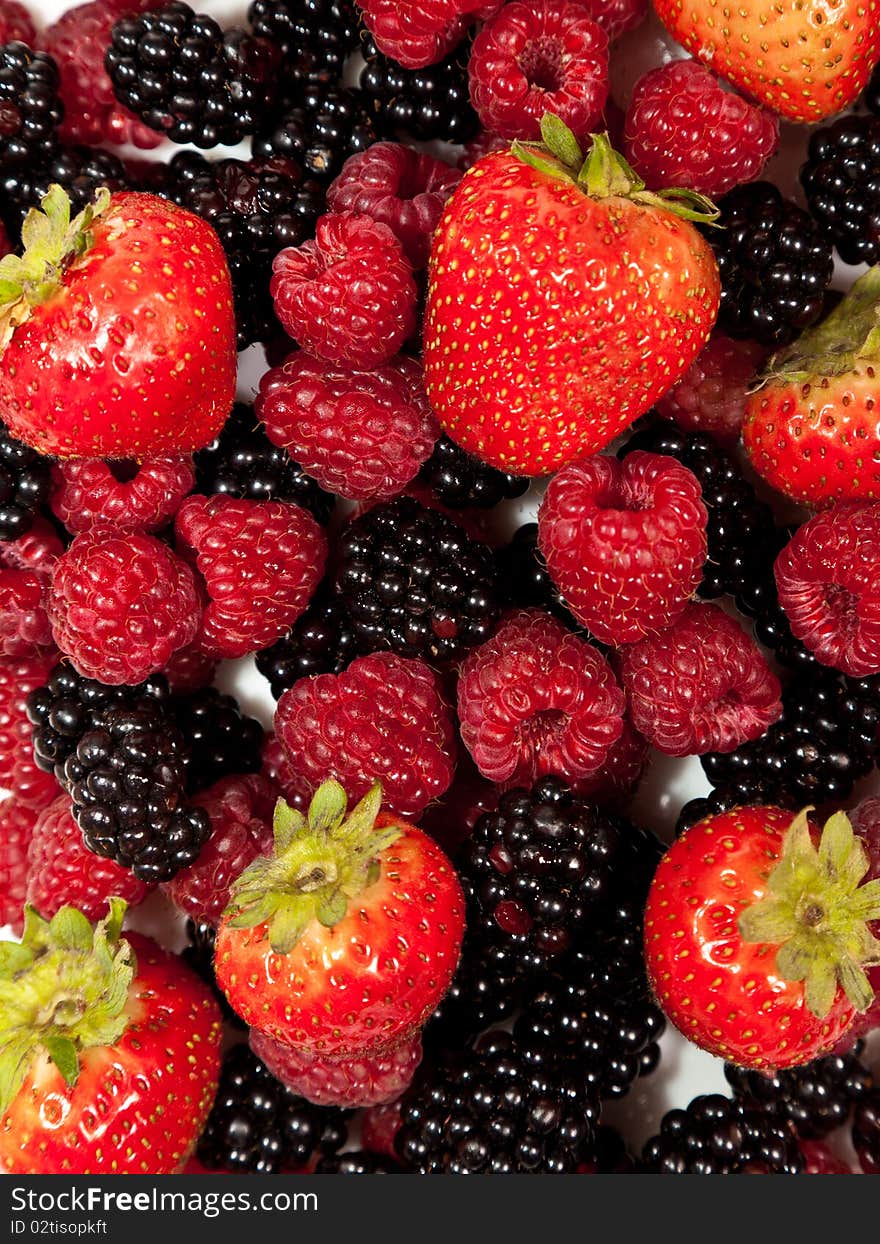 Composition of ripe black and red raspberries and strawberries