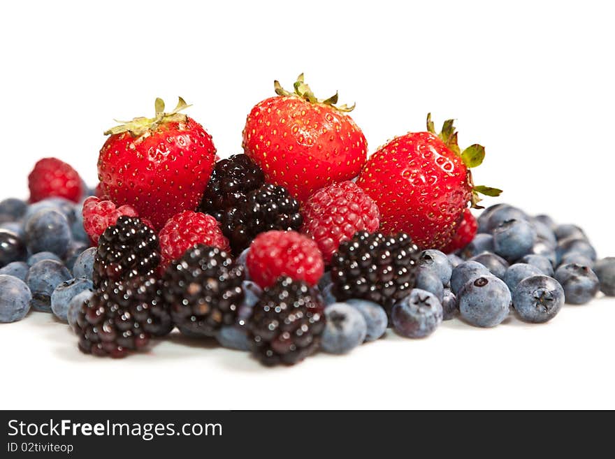 Composition of ripe black and red raspberries, strawberries and blackberries. Composition of ripe black and red raspberries, strawberries and blackberries