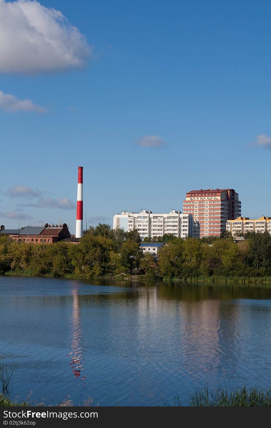 Russia, provincial city, buildings and boiler-house on riverside