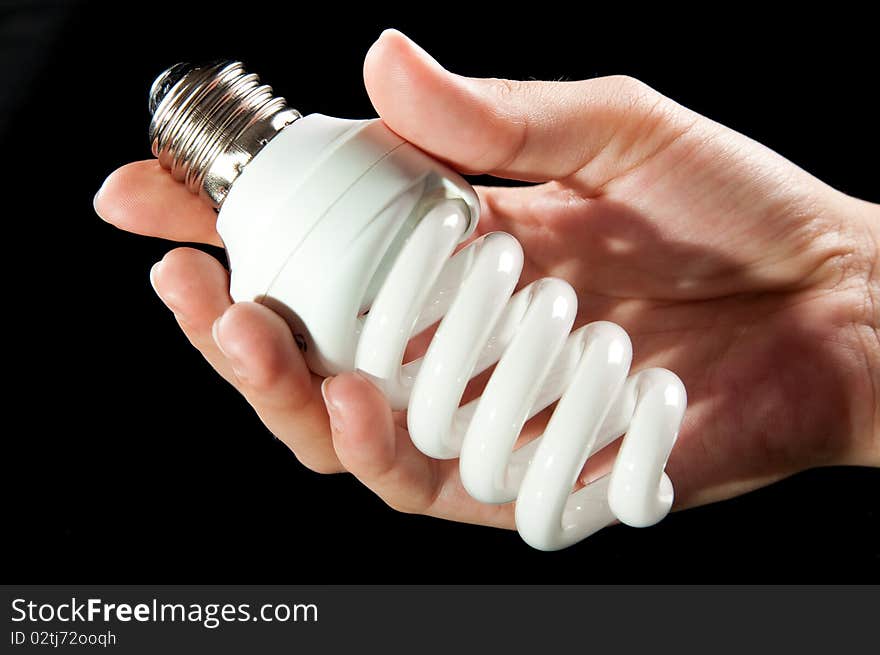 Energy saving light bulb in hand