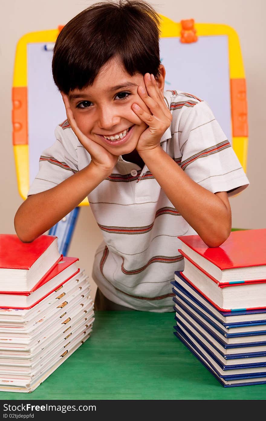 Cute Young Boy Resting On Books