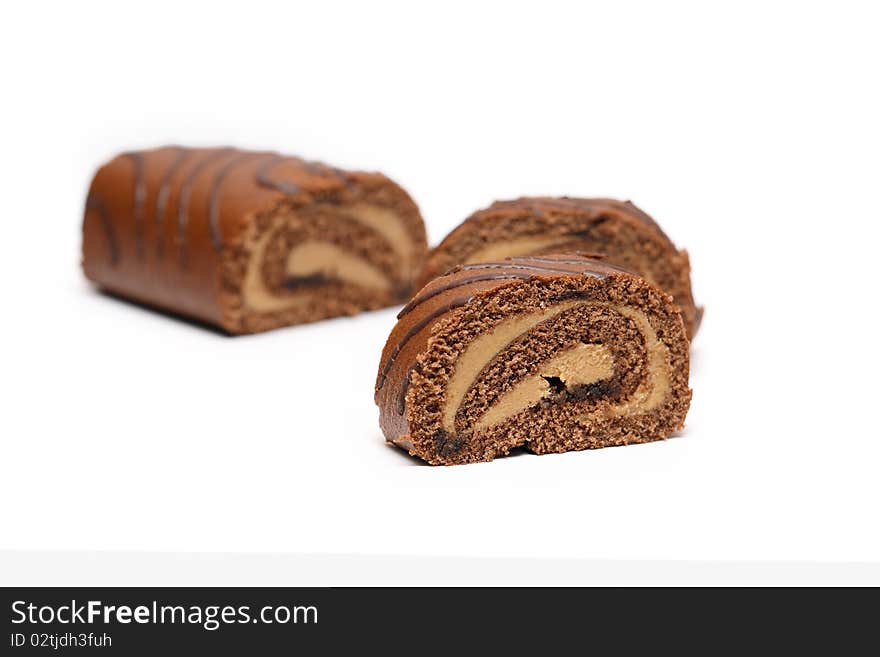 Sliced chocolate cake on white background