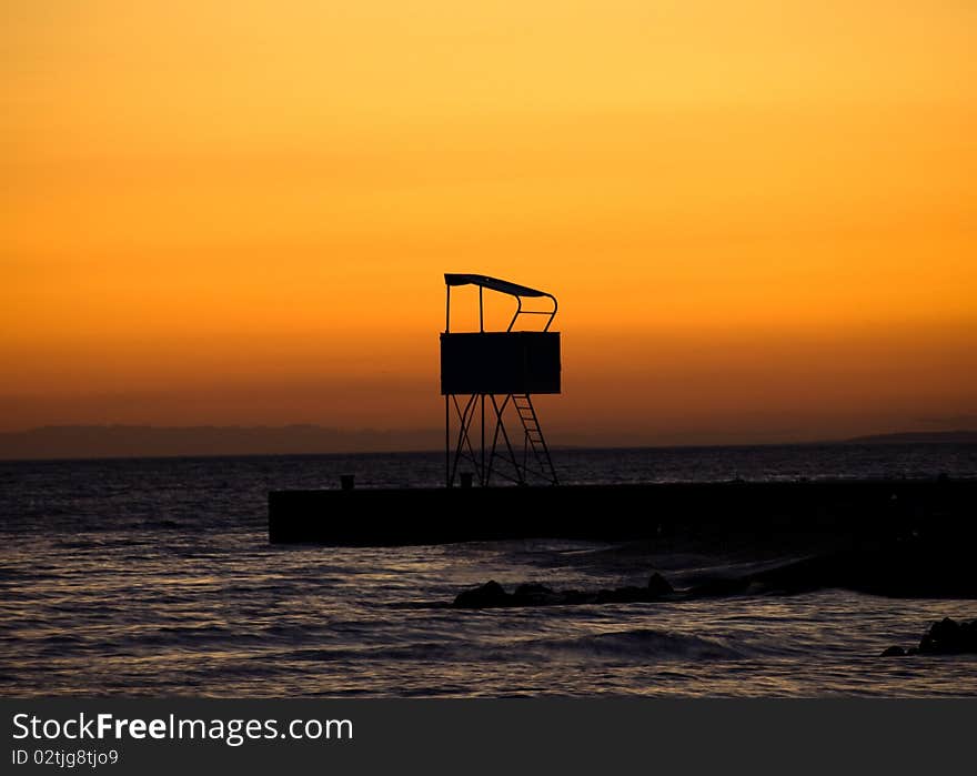 Romantic sunset background, lifeguard tower