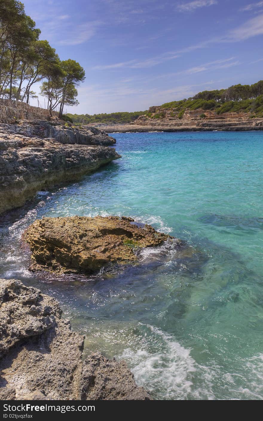 Vertical view of sea bay with turquoise water and rock shore. Mallorca, Spain