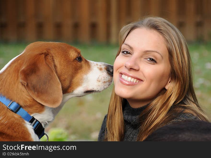 A beautiful girl enjoying a moment with her best friend. A beautiful girl enjoying a moment with her best friend.