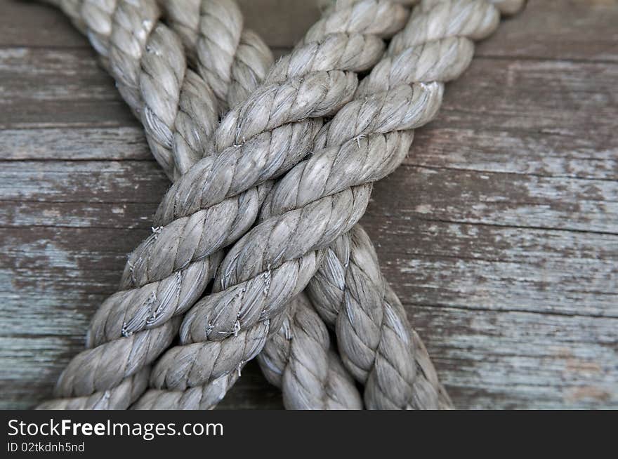 Detail of ropes lashed to a wood post. Detail of ropes lashed to a wood post