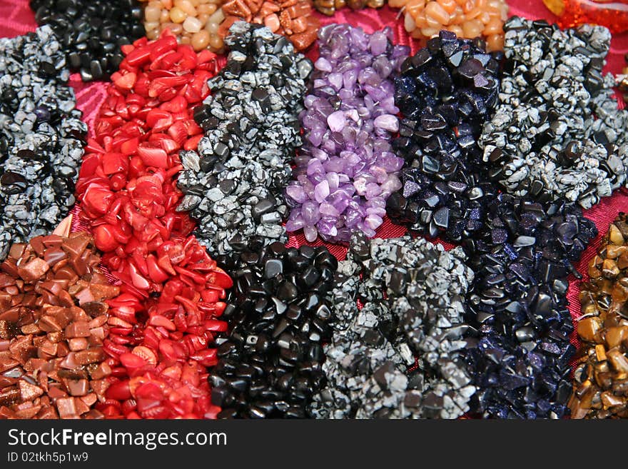 Natural background - shiny multi coloured semi precious and ornamental gem stones. Natural background - shiny multi coloured semi precious and ornamental gem stones