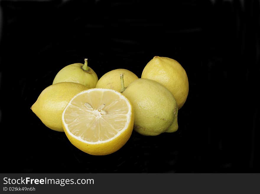 Ripe yellow lemons in isolated over black