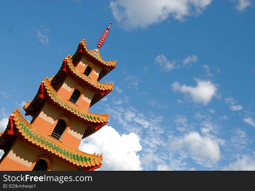 Chinese architecture set against a blue cloudy sky. Chinese architecture set against a blue cloudy sky.